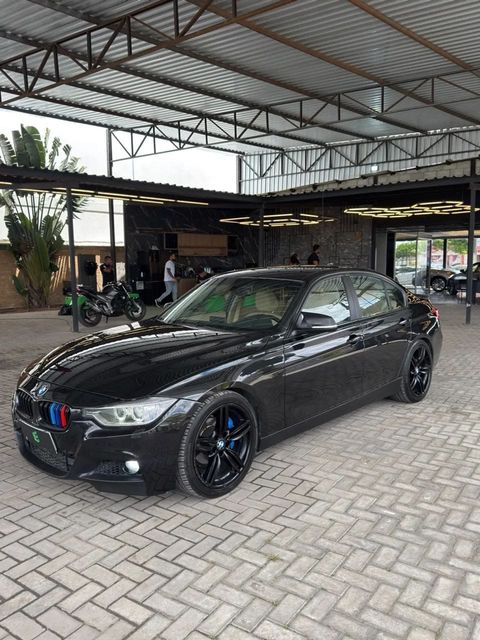 BMW 320i na cor preta, vista dianteira em três quartos (foto 1 de 17)